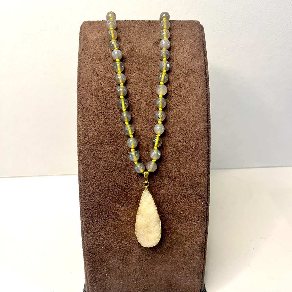 Druzy pendant on genuine stone necklace. With bold bright yellow knots in btwn